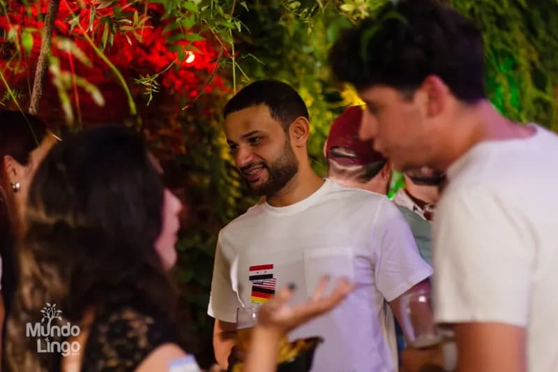 Conversation with visible flag stickers against a living green wall