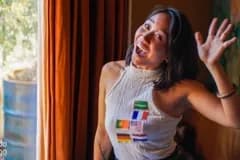 Ambassador waving with flag stickers and badge