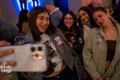 Friends taking a selfie with flag stickers at an event